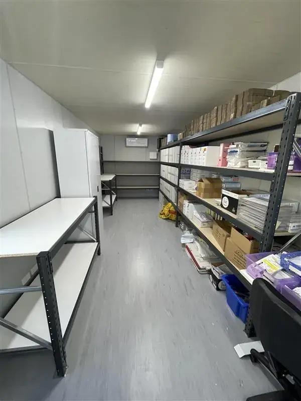 Shelving and workbench storage arranged in a compact storeroom